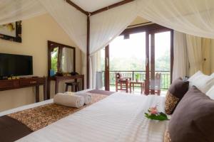 a bedroom with a bed with towels on it at Secret Forest Hideaway near Ubud in Bangli +38 photos