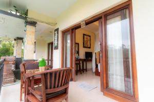 a living room with a sliding glass door at Secret Forest Hideaway near Ubud in Bangli