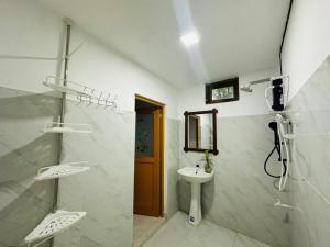 a bathroom with a sink and a toilet and a mirror at Sigiri Gateway in Galewela +43 photos