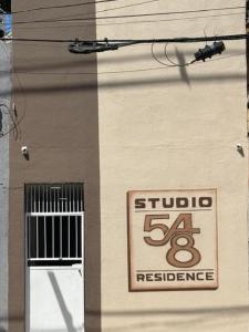 a building with a sign on the side of it at Loft Gracas Inn in Recife