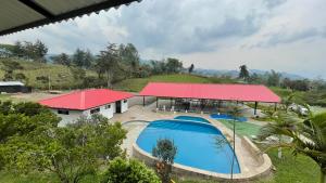 an aerial view of a house with a swimming pool and a red roof at Hotel Campestre Kambra in Garagoa