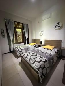 a bedroom with two beds and a window at Sunset Villa in Senggigi +39 photos