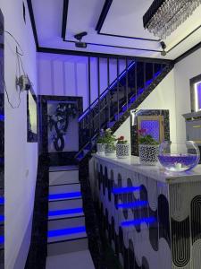 a purple room with stairs and blue lighting at Hotel Ravshanbek in Samarkand