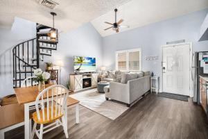 a living room with a couch and a table at Steps 2 beach Ocean view Pool Parking in Brigantine
