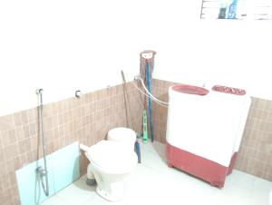 a bathroom with a toilet and a shower at Rich nest apartments colva in Colva +20 photos