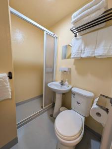 a small bathroom with a toilet and a sink at Travel Light in Tainan +26 photos