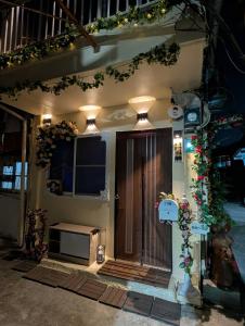 a front door of a house with lights on it at Travel Light in Tainan