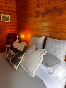 a bed in a room with white pillows on it at White Croft Cottage in Ross