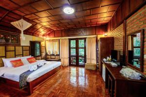 a bedroom with a bed and a television in it at Marisa Resort & Spa Chiang Dao in Ban Muang Ngai +83 photos