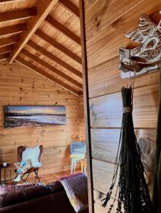 a living room with a couch and a wooden ceiling at White Croft Cottage in Ross