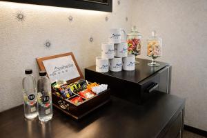 a room with a table with drinks and a tray of candy at Arabella Residence 2BR - New Cairo Luxury Stay in Cairo
