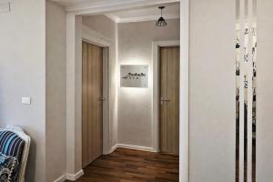 a hallway with two doors and a wall with a picture at Arabella Residence 2BR - New Cairo Luxury Stay in Cairo +16 photos