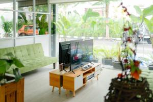 a living room with a television on a table at Naraséna Co-Living in Yogyakarta