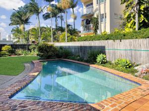 a swimming pool in front of a house at 1 Still Breeze in Maroochydore +4 photos