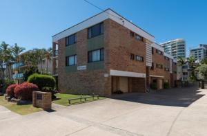 a brick building with a parking lot in front of it at 1 Still Breeze in Maroochydore