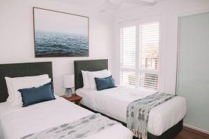 a bedroom with two beds and a window at Salt @ South West Rocks in South West Rocks +120 photos