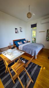 a bedroom with a bed and a table in it at Balay Mariposa in Langagan