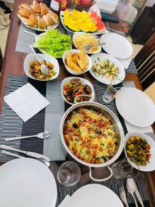 a table with many plates of food on it at Nature Villa in Tangalle