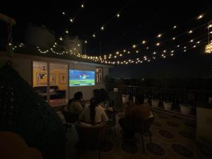 a group of people sitting in chairs watching a screen at Gurgaon 21 Tonic & Twinkle in Gurgaon