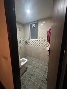a bathroom with a toilet and a sink at Gurgaon 21 Tonic & Twinkle in Gurgaon