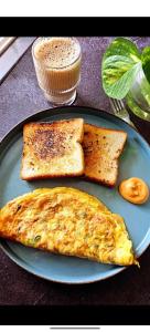a blue plate with eggs and toast on a table at Gurgaon 21 Tonic & Twinkle in Gurgaon