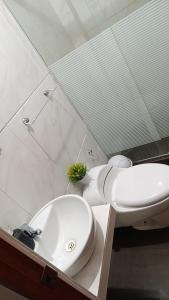a bathroom with a white toilet and a sink at Hospedaje Dajoka's in Lima +20 photos