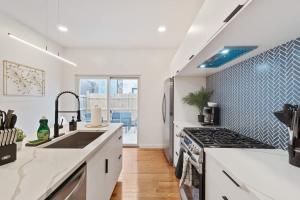 a kitchen with a sink and a stove at 3 BDRM 2 and a Half Bath - House Private Yard Duplex in Pittsburgh