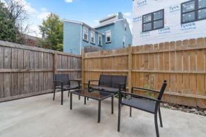 a patio with four chairs and a table and a fence at 3 BDRM 2 and a Half Bath - House Private Yard Duplex in Pittsburgh +24 photos