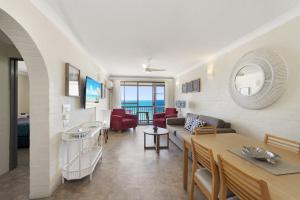 a living room with a couch and a table at Don Pancho Beach Resort in Bargara