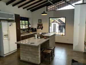 a kitchen with a counter and a refrigerator at Finca San Pablo in Subachoque