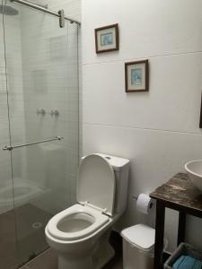 a bathroom with a toilet and a glass shower at Finca San Pablo in Subachoque +61 photos