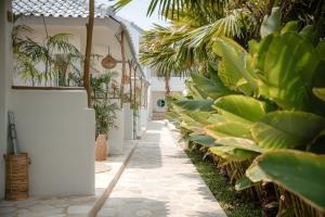 a hallway with a row of plants in a building at Quma Boutique Hotel - Adults Only in Gili Trawangan
