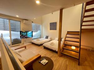 a bedroom with a bunk bed and a living room at Haus128 in Sapporo