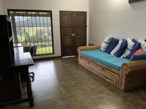 a living room with a couch and a window at Finca San Pablo in Subachoque
