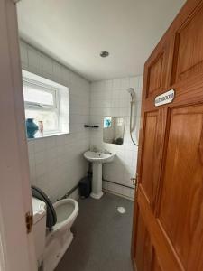 a bathroom with a toilet and a sink at Near city centre, Derby train station and royal Derby hospital in Derby