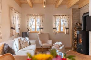 a living room with a couch and chairs and windows at Ebner 1822 in Gnesau