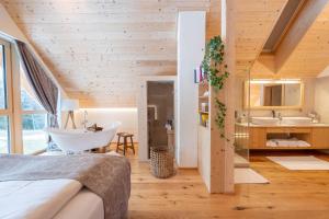a bedroom with a bathroom with a tub and a sink at Ebner 1822 in Gnesau +20 photos