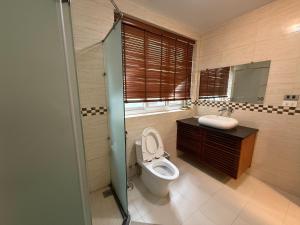 a bathroom with a toilet and a sink at Spuds&Bunks Hostel in Hanoi