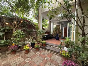 a porch with many potted plants on a house at Spuds&Bunks Hostel in Hanoi
