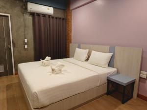 a bedroom with a bed with two animals on it at TK Thongrak Apartment in Hat Yai