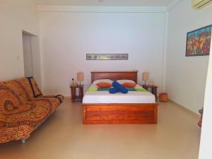 a bedroom with a bed and a chair in it at Coconut Villa in Bentota +42 photos