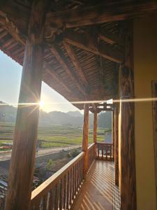 a balcony of a house with a view of the countryside at PiTu Homestay in Dồng Văn
