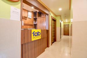 a lobby of a hotel with a sign on the wall at FabHotel Iubit in kolkata