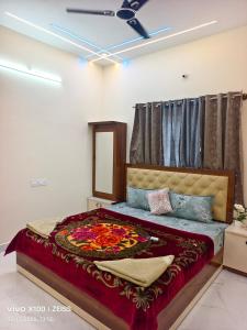 a bedroom with a large bed in a room at YELAGiRI GRAND PALACE in Yelagiri