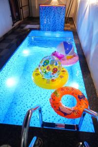 a swimming pool with toys in the water at YELAGiRI GRAND PALACE in Yelagiri