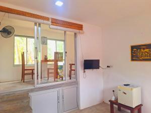a living room with a window and a tv at Coconut Villa in Bentota