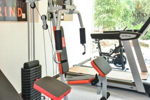 a gym with a treadmill and a squat rack at Agbo Hotel in Polonnaruwa