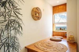 a room with a table and a plant and a window at Stay Cherry in Seogwipo