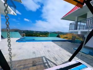 a view from the balcony of a house with a swimming pool at Samudra Retreats Vagamon in Vagamon