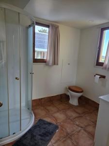 a bathroom with a shower and a toilet at Paradise in the city in Christchurch +7 photos